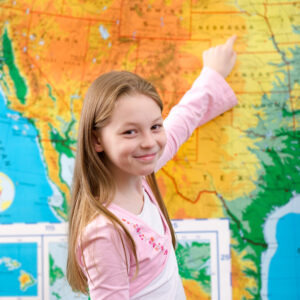 Young girl pointing at map